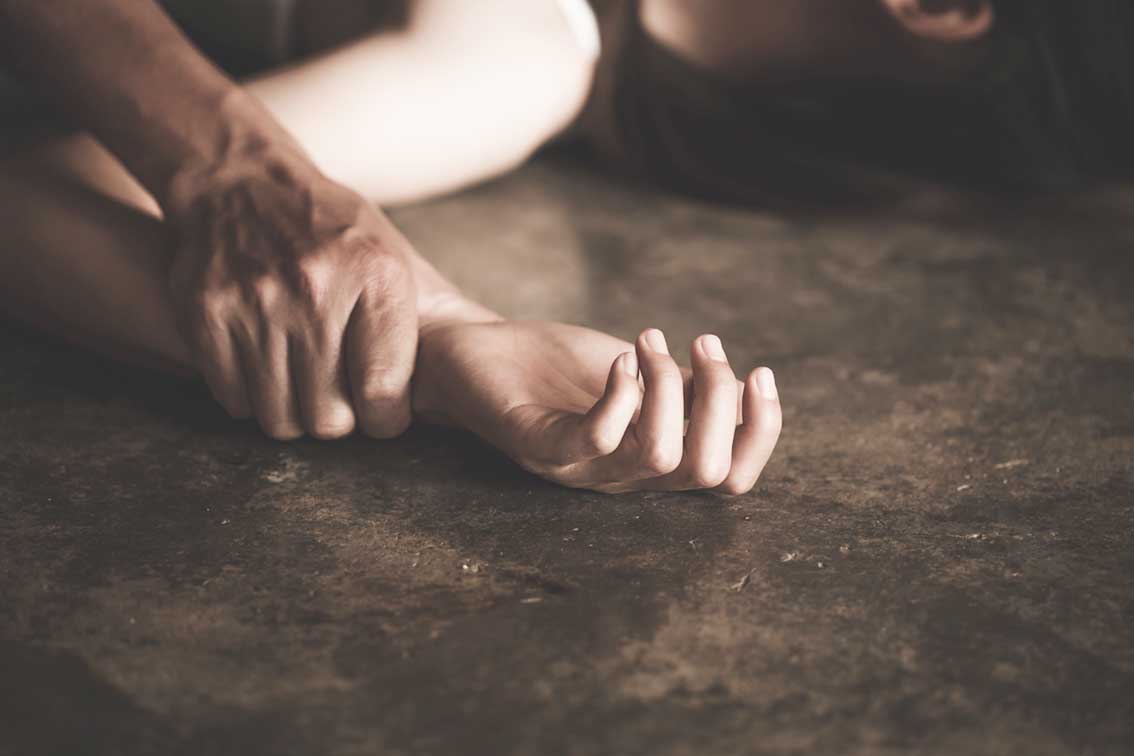 a,man's,hand,holding,a,woman,hand,for,rape,and